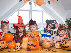 Group of kids drawing on pumpkins