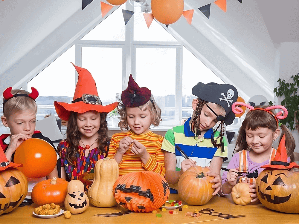 Group of kids drawing on pumpkins